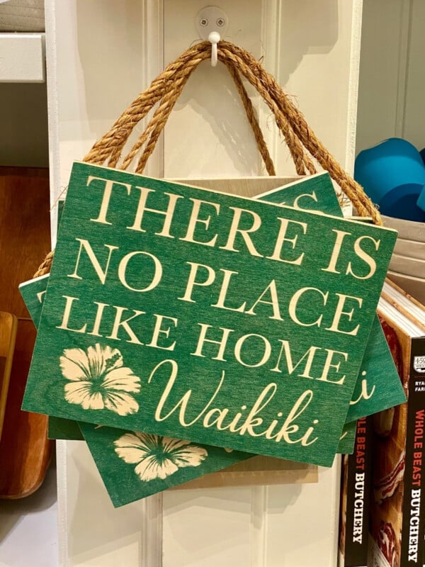 A home decor sign "There's No Place Like Home Waikīkī".
