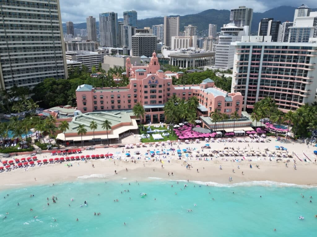 An aerial view of Waikīkī Beach, highlighting the iconic Royal Hawaiian Hotel.