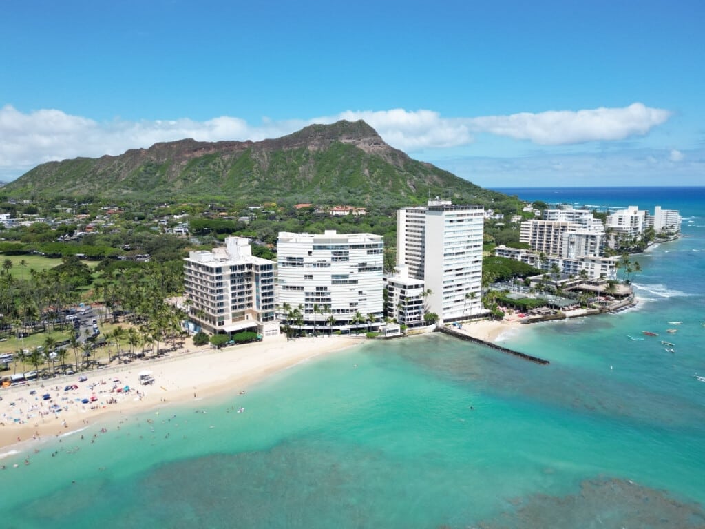 Aerial view of Waikīkī’s Gold Coast with Diamond Head in the background.