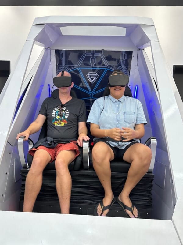 Two people using virtual reality in a pod at Odyssey VR in the International Market Place in Waikīkī.