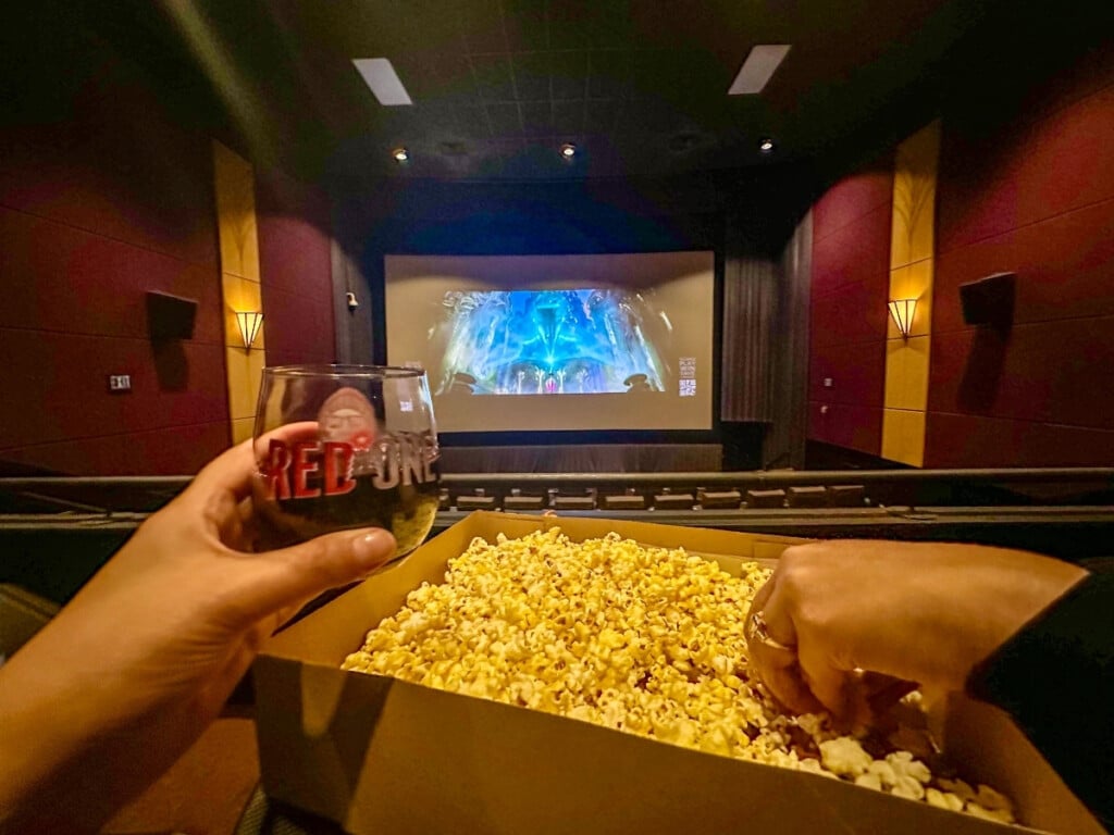 Luxury movie experience at Consolidated Theatres Ward with TITAN LUXE
featuring a cozy cinema set up, fresh popcorn and a glass of wine.