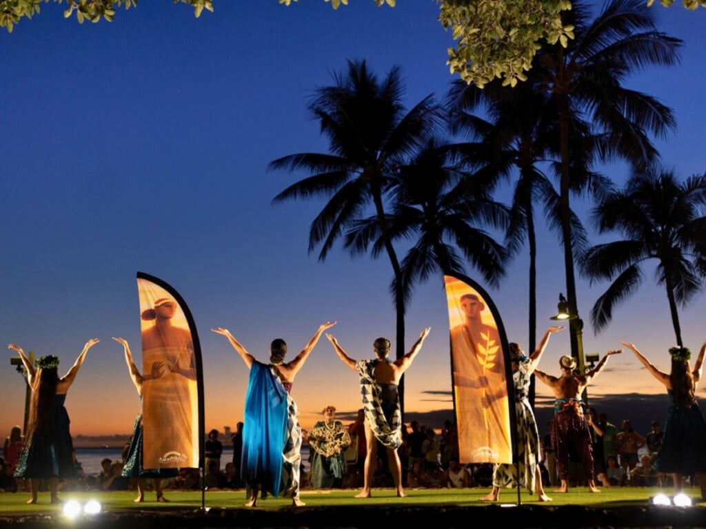Performers on stage during The Return of Kapaemahu Hula Show at the Kūhiō Beach Hula Mound.
