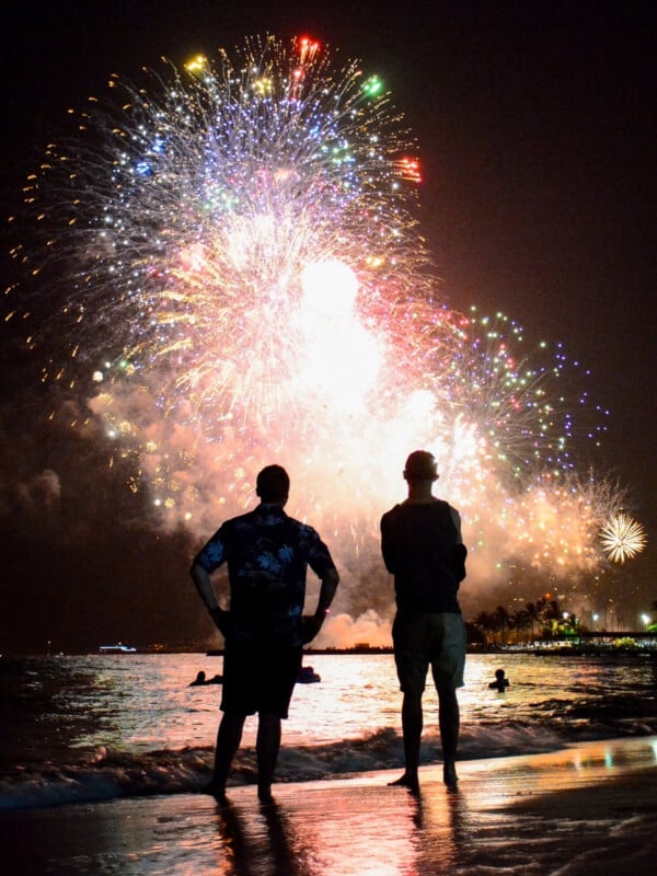 Fireworks going off over a beach in Waikīkī, Oʻahu.