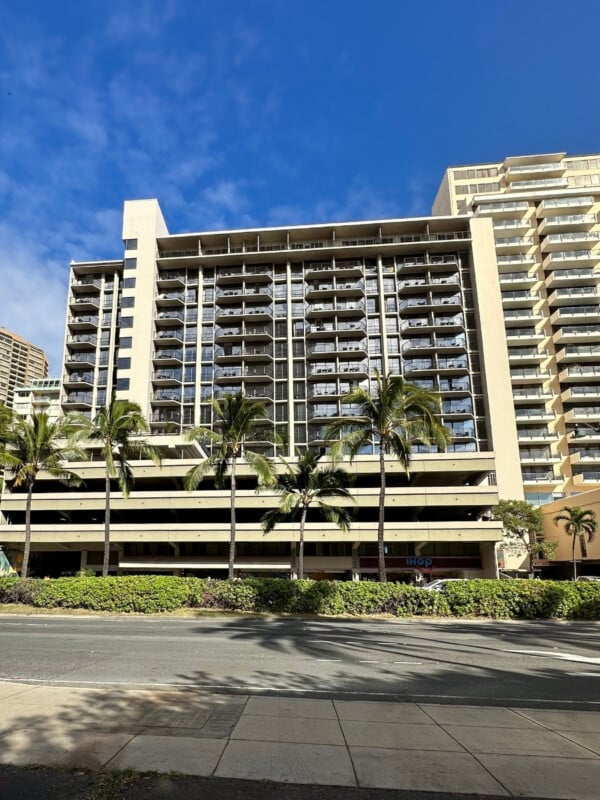 The Aqua Palms Waikiki Hotel building with palm trees
