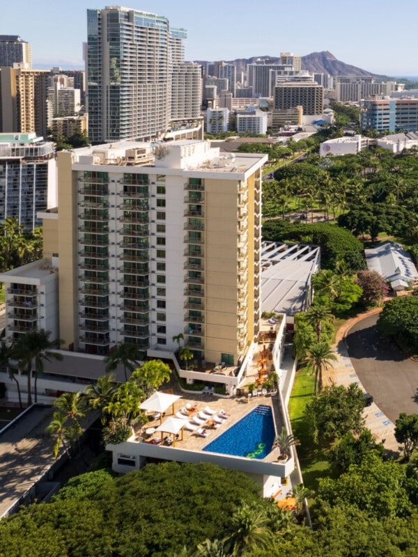 The Luana Waikiki Hotel & Suites at the gateway to Waikīkī with Diamond Head in the background