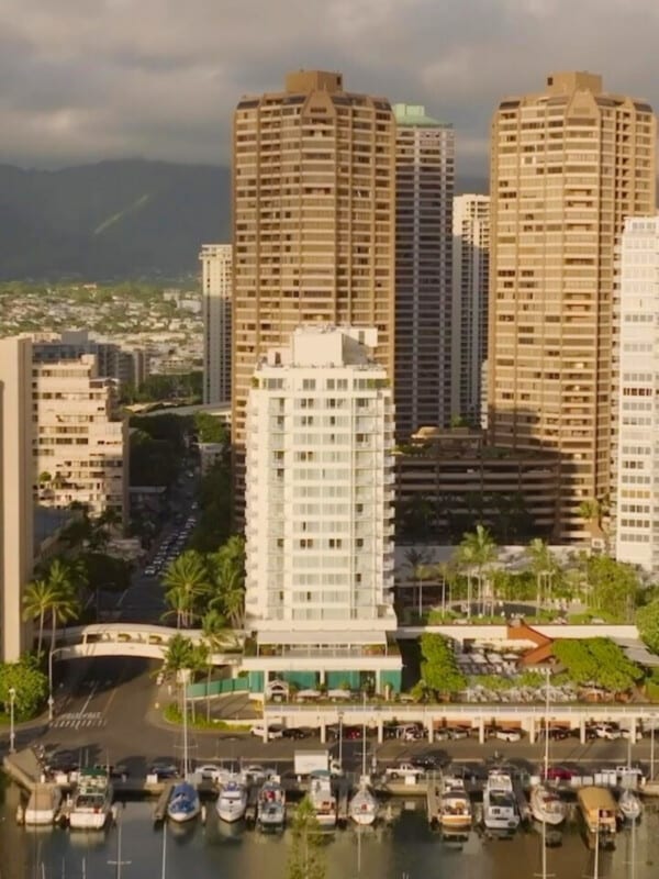 An aerial of The Modern Honolulu by Hilton Vacation Club by the Ala Wai Boat Harbor in Waikīkī
