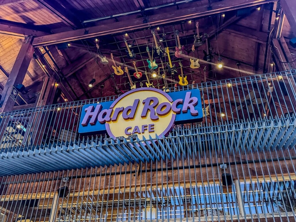 Close up of Hard Rock Cafe Honolulu logo signage at night.