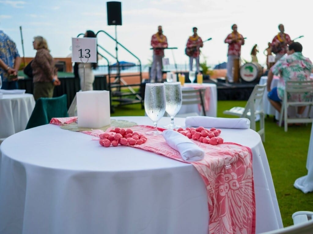 The Aha‘aina Luau shines with its pink Hawaiian themed decor and table arrangements, perfectly capturing the spirit of the iconic ‘Pink Palace’.