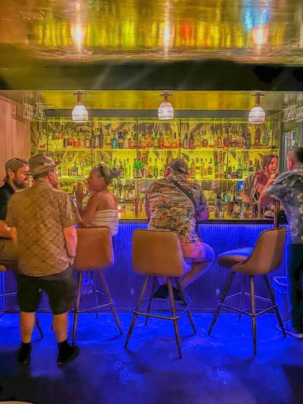Bar tender serving guests at the Green Lady cocktail room in Waikīkī.