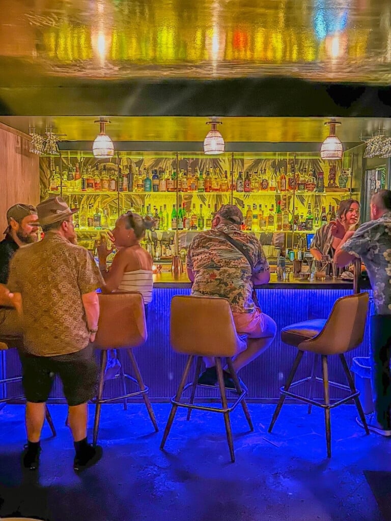 Bar tender serving guests at the Green Lady cocktail room in Waikīkī.
