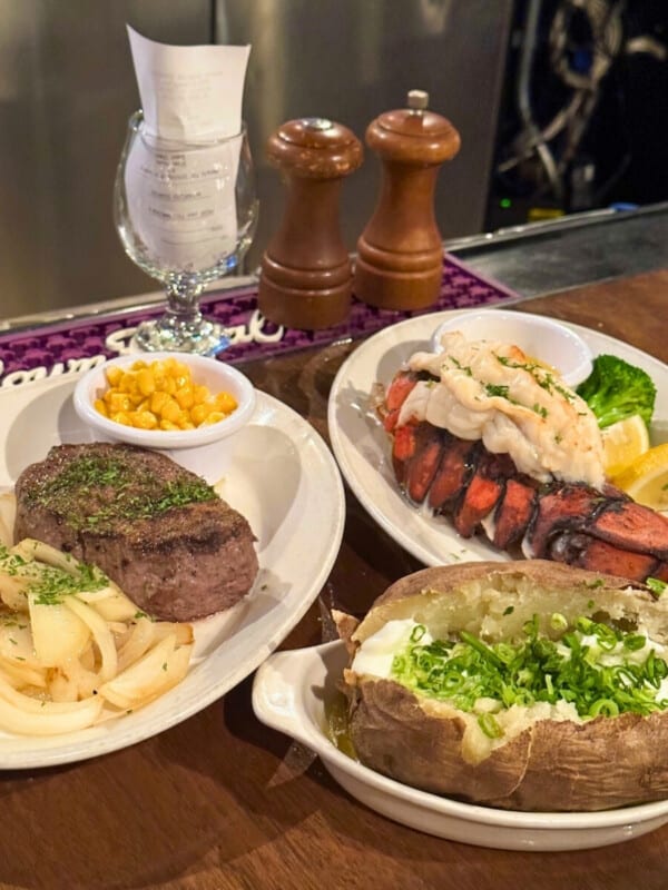 Steak, lobster and baked potato served at the bar in d.k Steak House restaurant in Waikīkī, Oʻahu, Hawaiʻi.