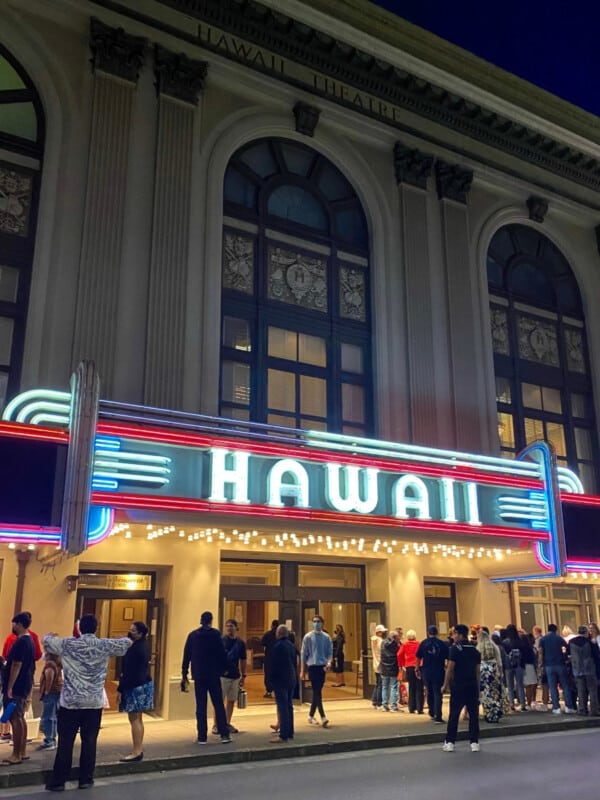 The exterior of the Hawaiʻi Theatre Center in Downtown Honolulu with a vibrant HAWAII sign.