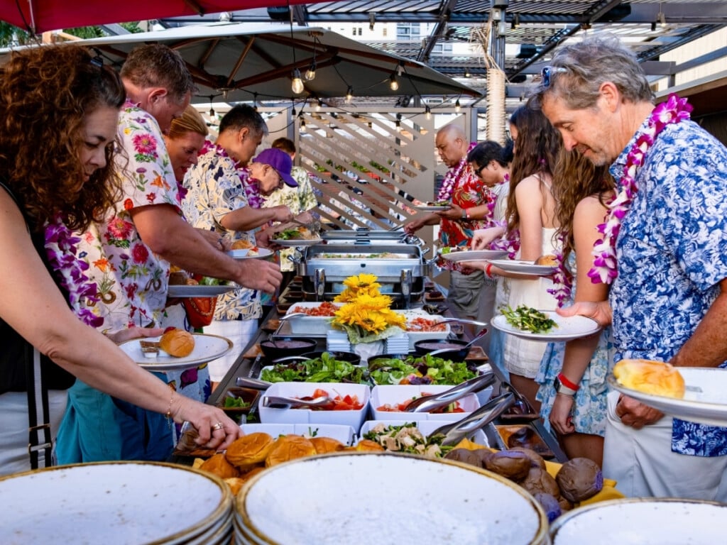 Guest serving themselves at the buffet of Pāʻina Waikīkī Luau.