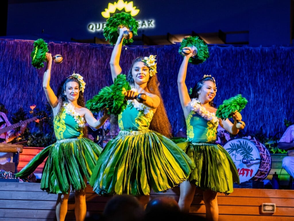 Authentic Hawaiian Hula performance with dancers dressed in traditional Hawaiian attire at Pāʻina Waikīkī Luau.