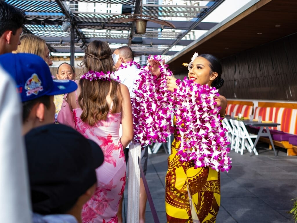 Welcome lei greeting at the Pāʻina Lūʻau Waikīkī.