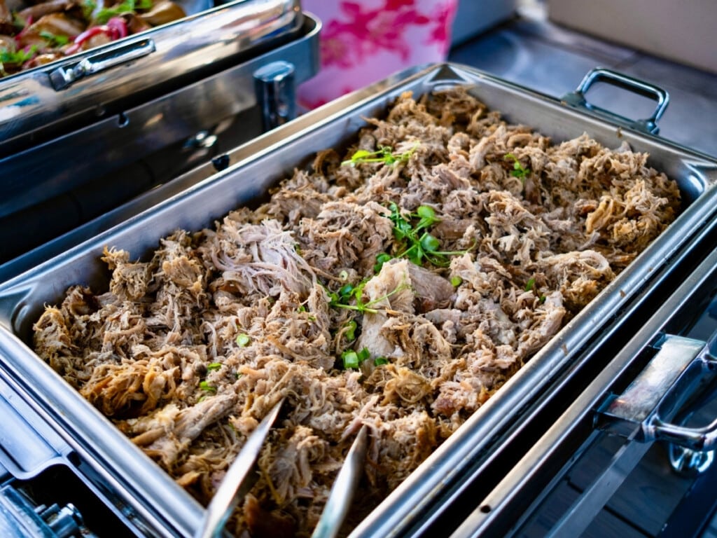Bain-marie filled with above Ground Smoked Kalua Pork at Pāʻina Waikīkī Luau.