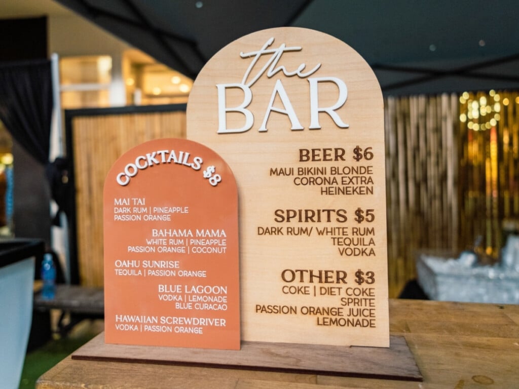 he bar menu offering classic Hawaiian cocktails including Mai Tais and Oahu sunrise as well as beer, spirits and soft drinks at the Queens Waikiki Luau.