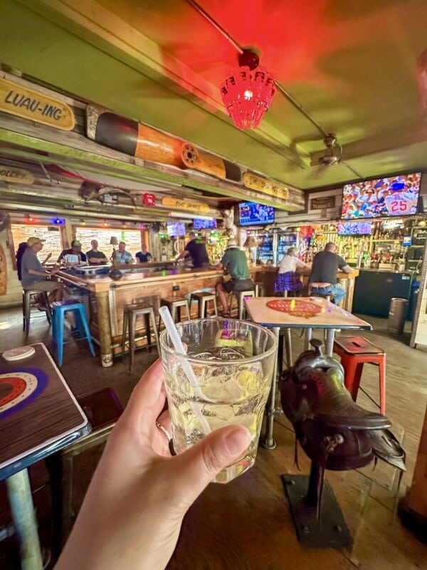 Cheers-ing with a vodka soda inside of Suzie Wong's Hideaway.