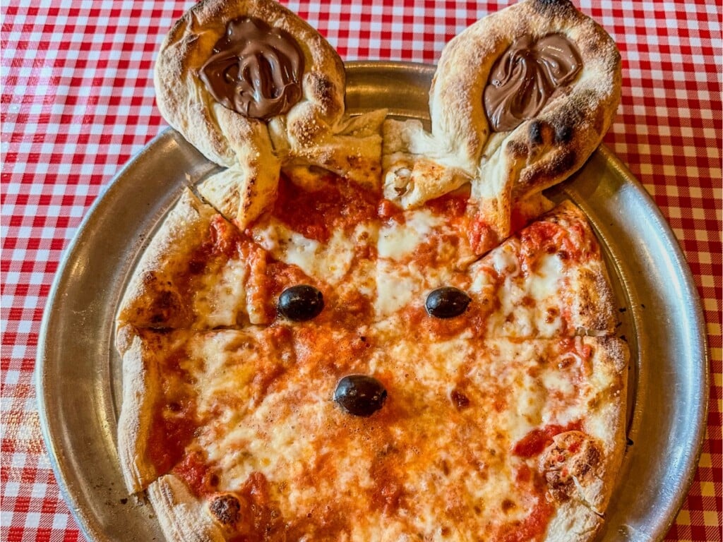 Kids margarita pizza with bunny ears, on a red and white tablecloth taken at Arancino on Beachwalk in Waikīkī.