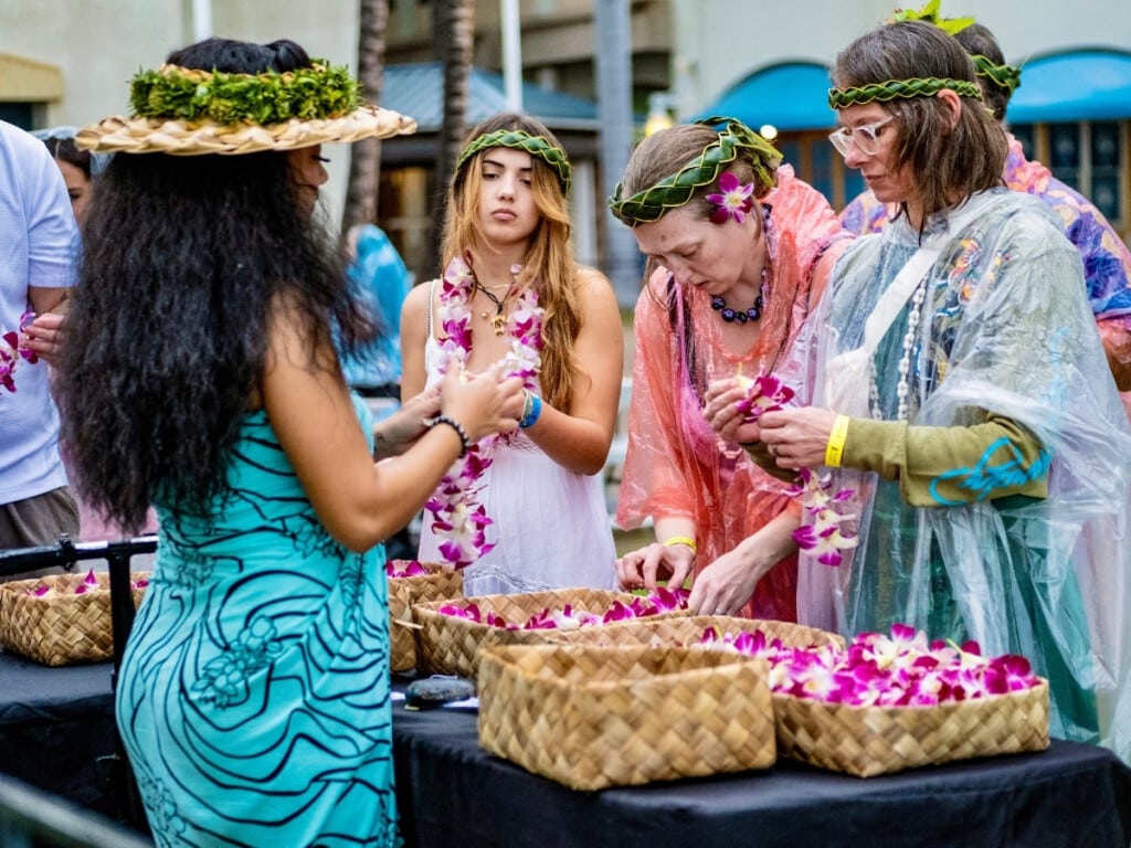 The lei and bracelet making station at Ka Moana Luau where guests are making fresh orchid bracelets and lei.