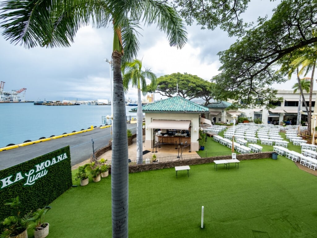 The Ka Moana Luau takes at the Aloha Tower Marketplace. This lūʻau sits on a lush green lawn dotted with palms offers water views.
