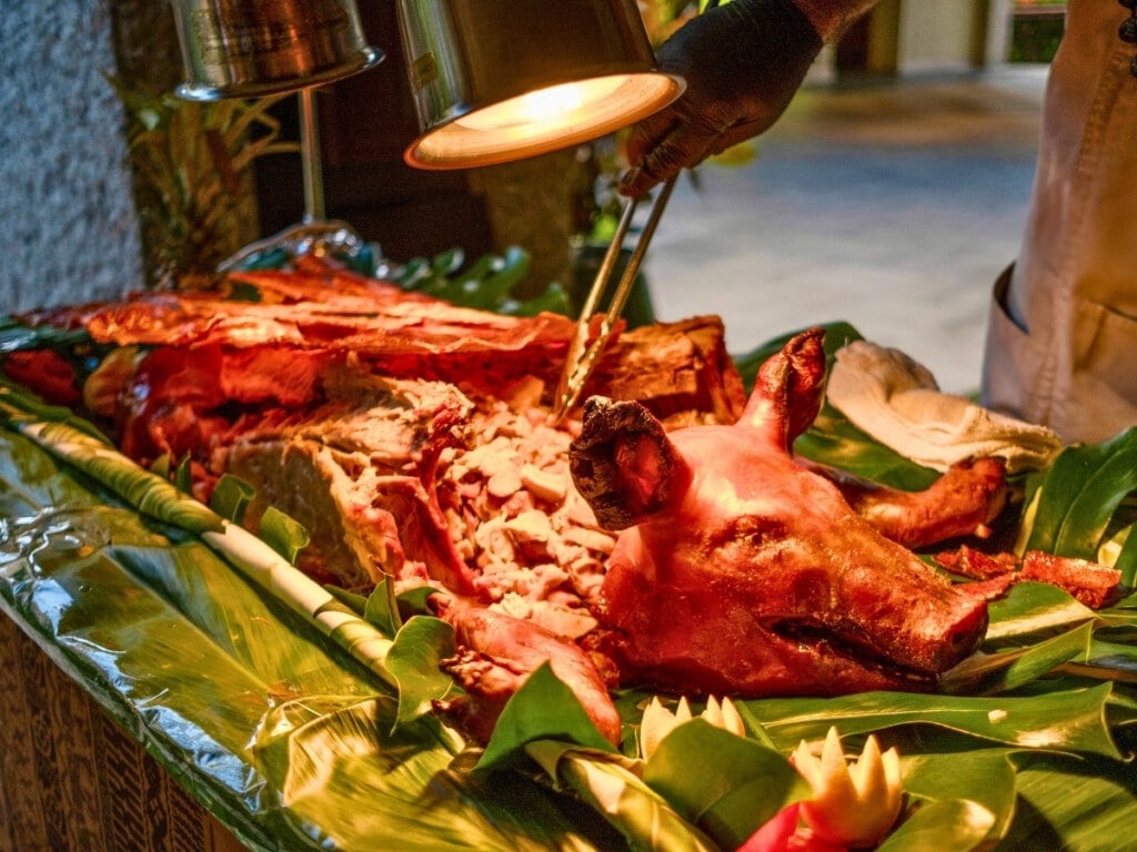 Island Roasted Whole Suckling Pig on a bed of green banana leaves at the Waikiki Luau Buffet & Rock-A-Hula Show.
