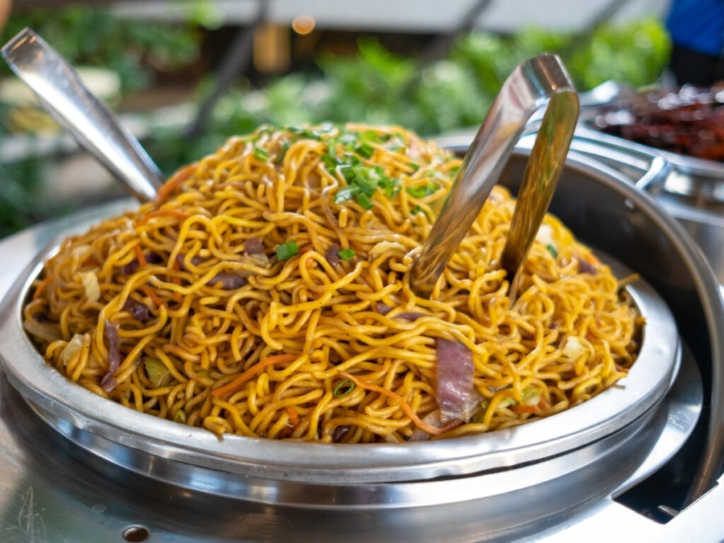 A bowl of fried noodles from the buffet line of Waikiki Luau Buffet & Rock-A-Hula Show.
