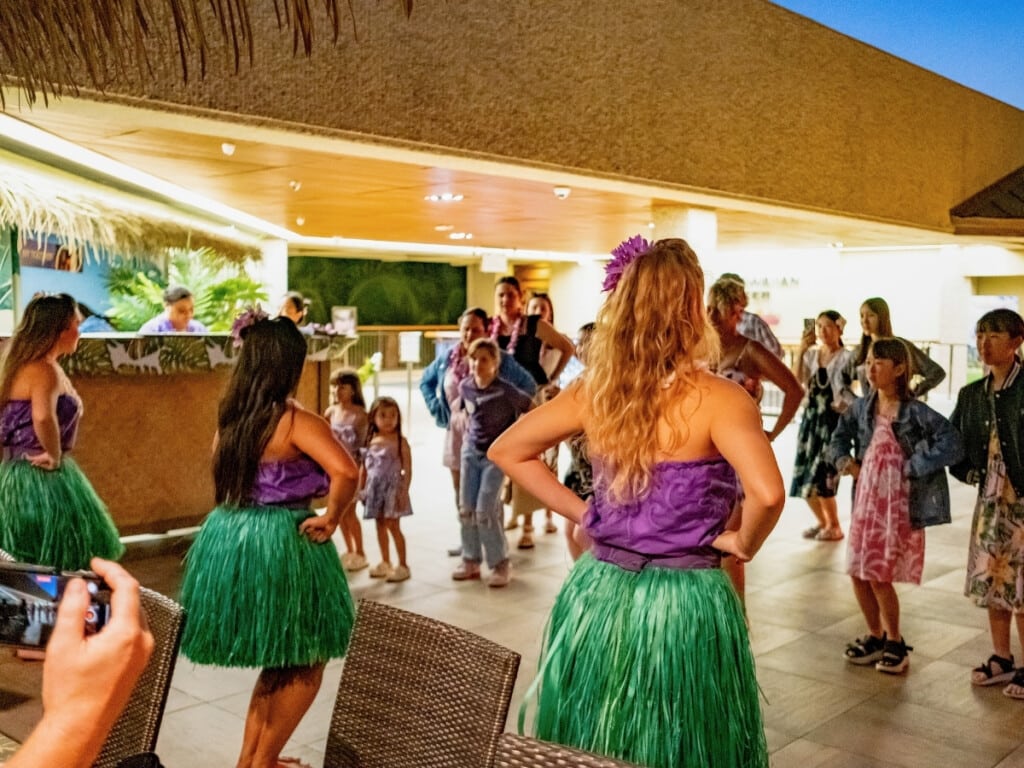 Guests of all ages experience an interactive hula lesson at the Waikiki Luau Buffet & Rock-A-Hula Show.