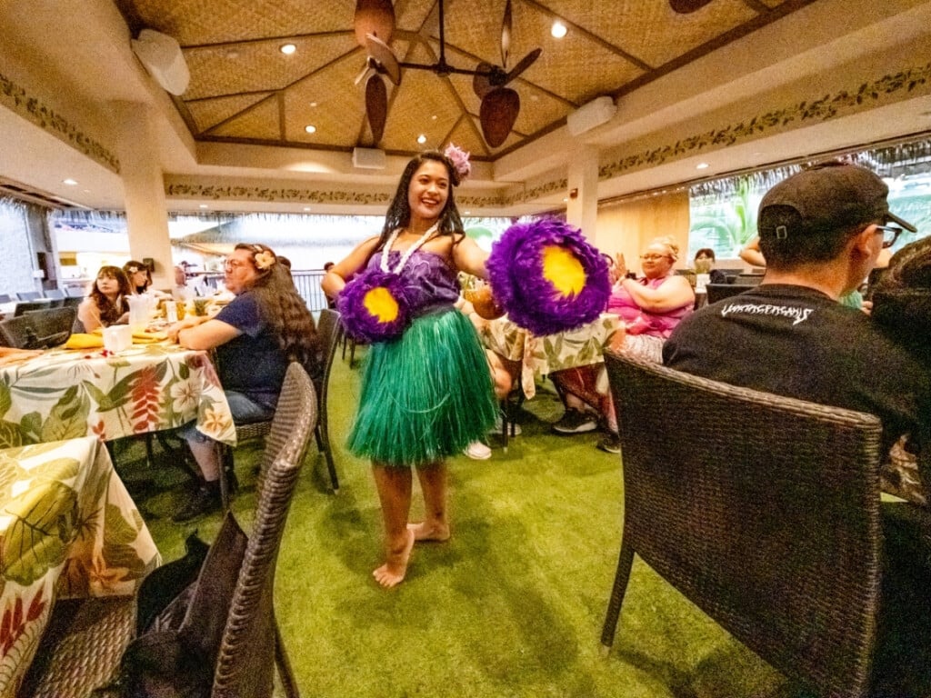 Hula dancer performing in the isles amongst the tables at Waikiki Luau Buffet & Rock-A-Hula Show