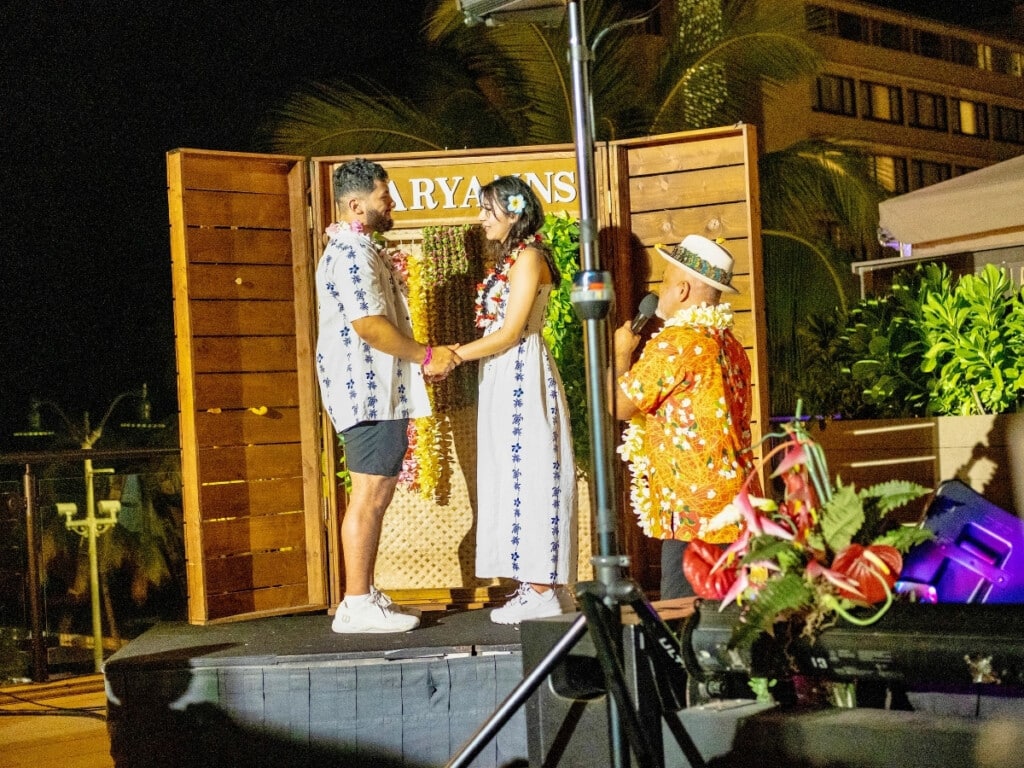 A young couple shares a special moment on stage at the Nā Lei Aloha Waikīkī lūʻau.