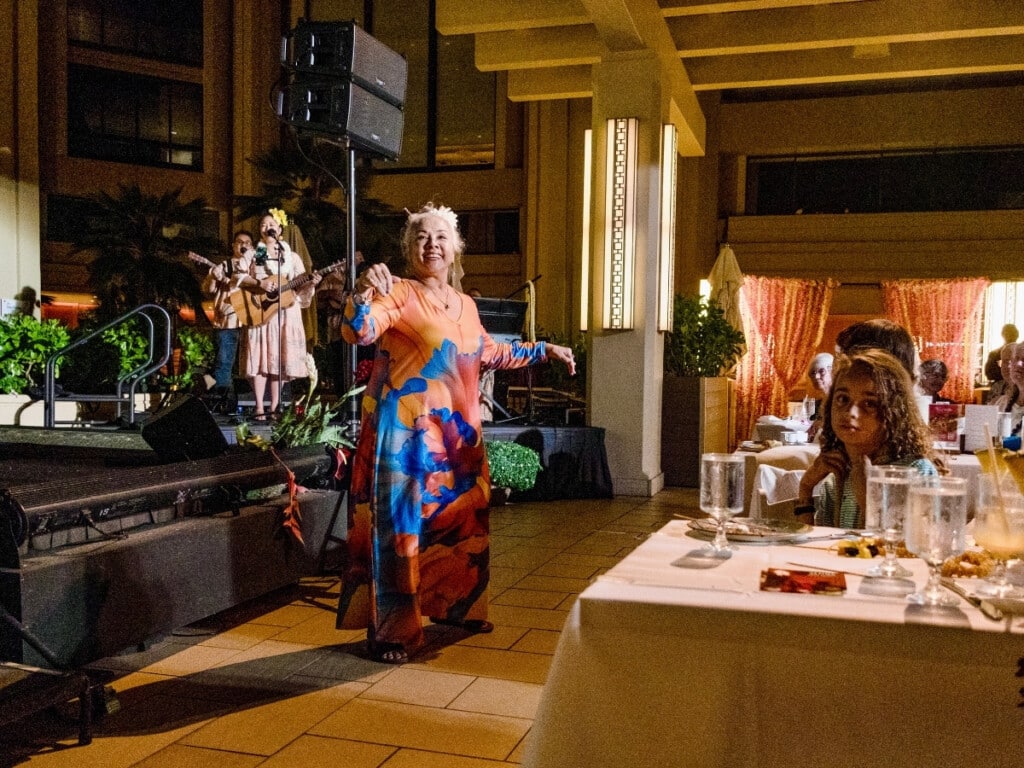 Tūtū wahine (Grandma in Hawaiian) performs a mesmerizing solo hula performance at the Nā Lei Aloha lūʻau.
