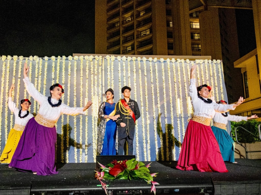 Dancers captivate the audience with elegant movements and traditional style honoring the stories of the Hawaiian monarchy at the Nā Lei Aloha Waikīkī lūʻau.