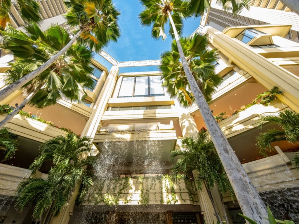 The Hyatt Regency Waikiki Beach Resort greets you with a jaw-dropping waterfall right in its lobby. This stunning setting also happens to be home to the Nā Lei Aloha lūʻau.