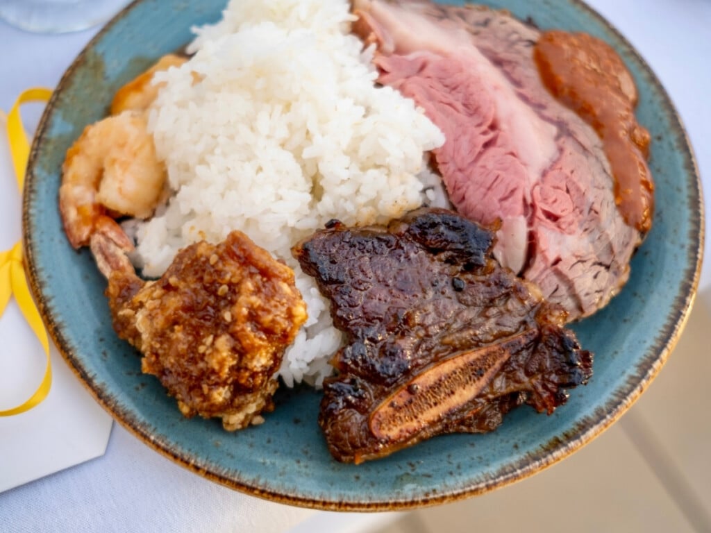 A full plate of tasty meats and on a bed of rice at Nā Lei Aloha lūʻau.