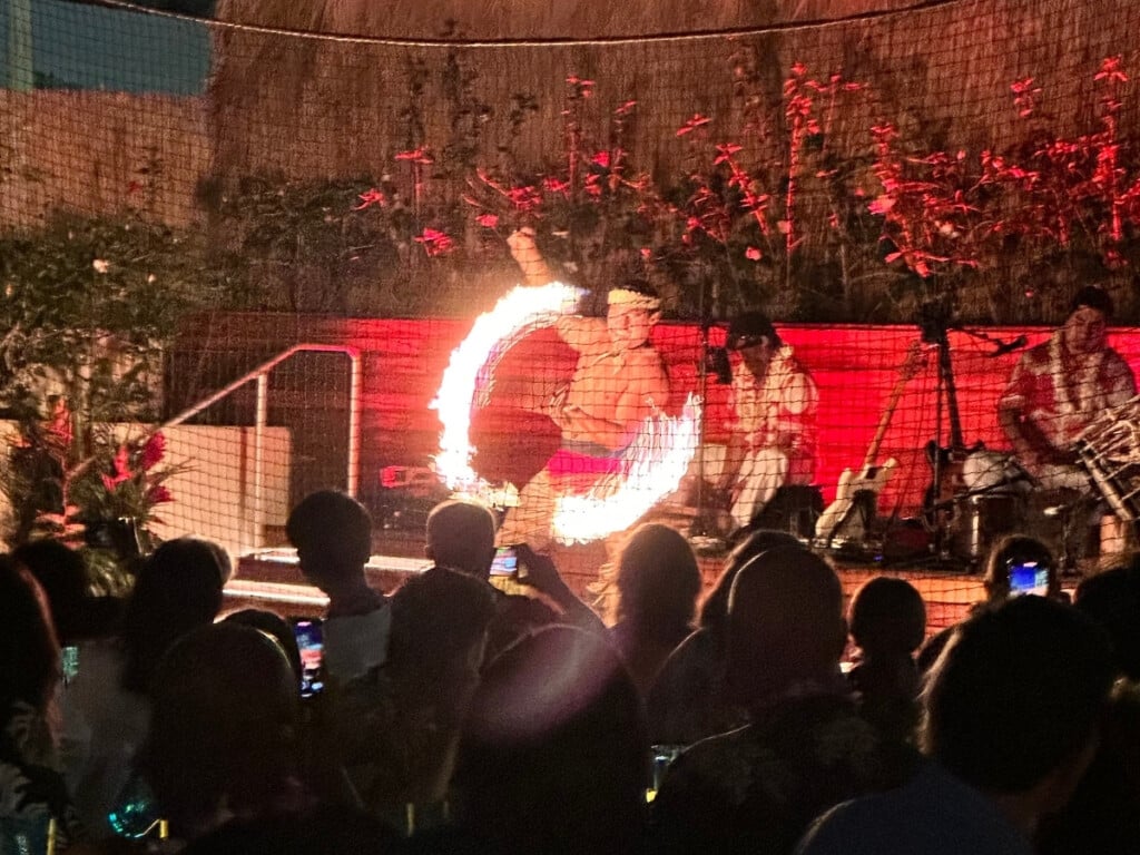 A fire dancer performing on stage at the Pāʻina Lūʻau Waikīkī at the Waikiki Beach Marriott.