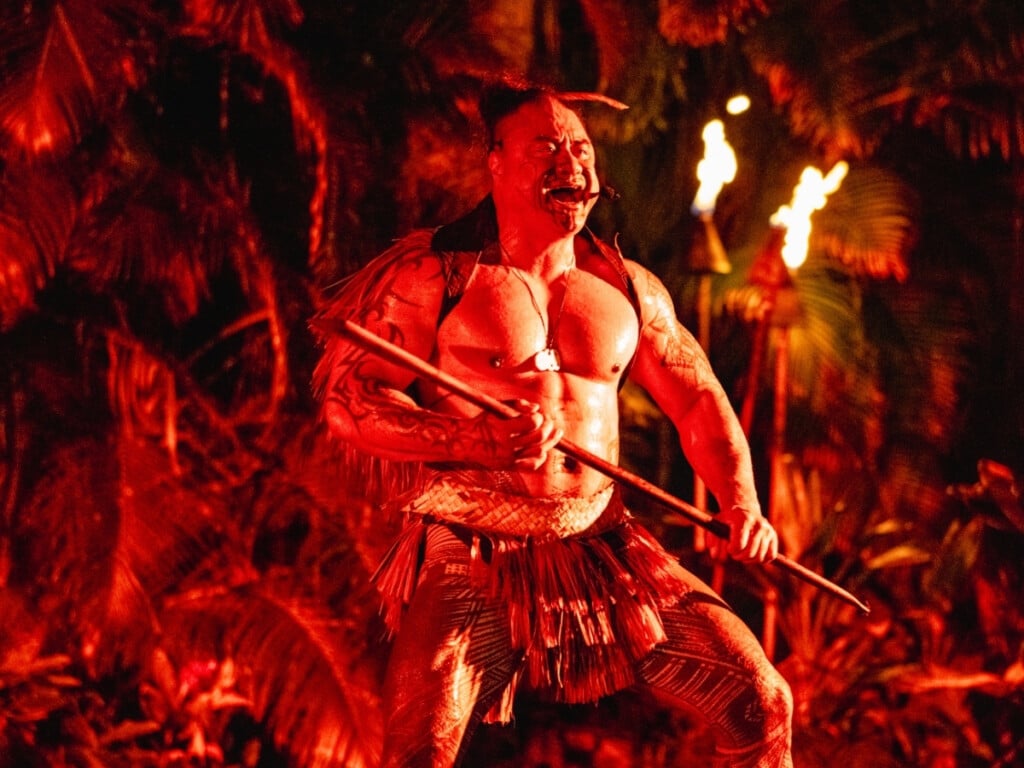 Powerful Māori performance at the Waikiki Starlight Luau featuring tropical setting an tiki torches in the background at the Waikiki Starlight Luau: Rooftop at the Hilton Hawaiian Village Waikīkī, O‘ahu, Hawaiʻi.
