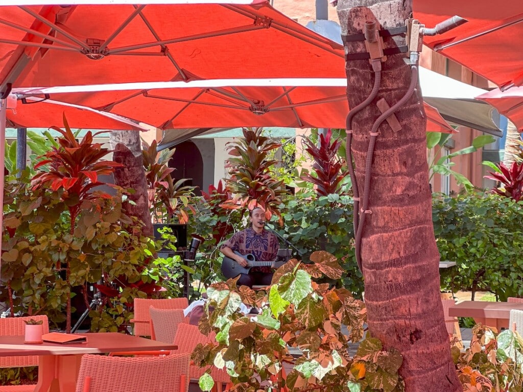 Live music under the pink umbrellas at The Royal Hawaiian resort in Waikīkī.