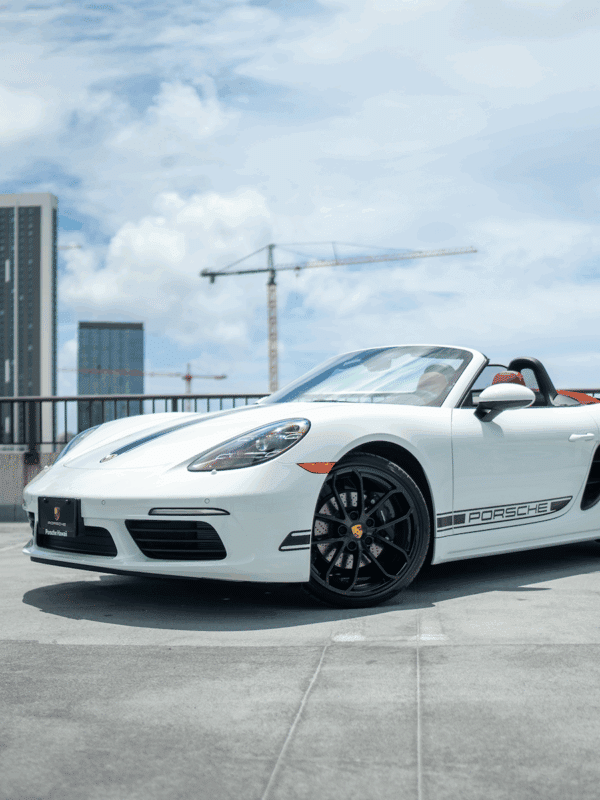 A white Porsche with a Honolulu background.